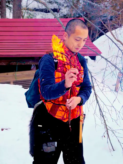 Matagi covering the human smell and giving gratitude to the gods before entering the mountain